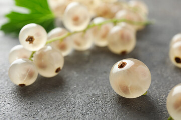 Fresh white currant berries on gray textured table, closeup