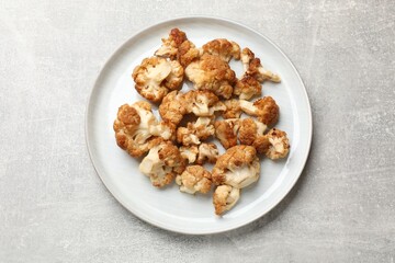 Baked cauliflower on light grey table, top view