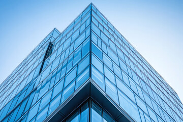 Obraz premium Corner of a glass office building under blue sky