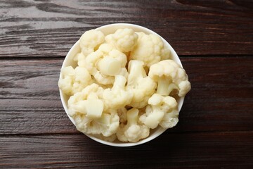 Tasty cooked cauliflower on wooden table, top view