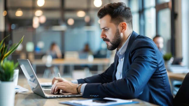 A professional attending an online training session on a laptop in a modern office setting