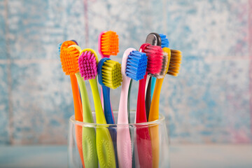 Toothbrush and toothpaste, squeezing toothpaste from tube onto toothbrush close-up. Daily oral care after meals concept.