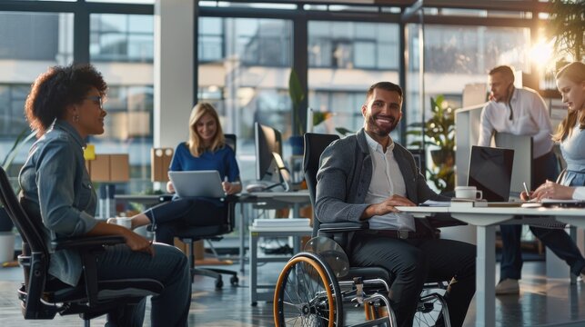 Business professionals with disabilities collaborating with coworkers in a modern, inclusive office environment.