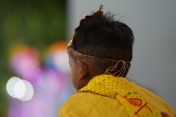 back shot of an indian boy as krishna