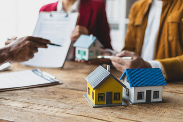 Fototapeta premium Businessman and real estate agents discussing documents signing a legal purchase of a house.