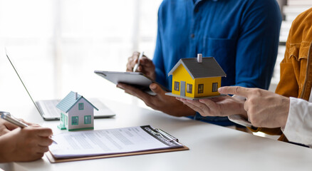 Businessman and real estate agents discussing documents signing a legal purchase of a house.