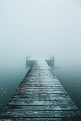 Fototapeta premium The misty dock is beautifully positioned over the water during the tranquil early morning hours