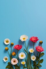 Fototapeta premium A blue background with a variety of colorful flowers, including daisies, roses