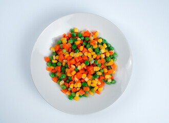 Organic Food. Mixed Vegetables Isolated White Background. Vegetable containing carrots, peas, and corn on white background, Healthy food, Colorful mixed vegetables.