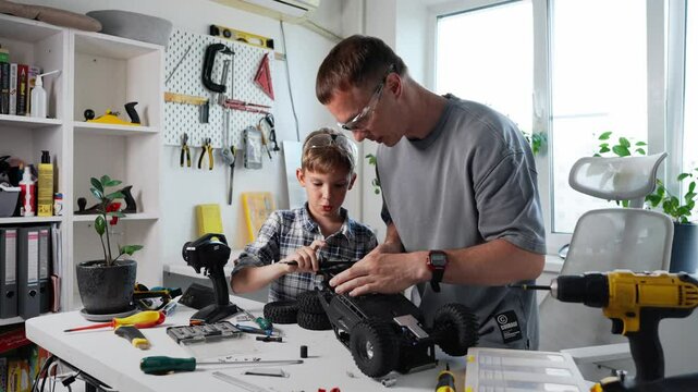 A Father and His Son Collaboratively Building a Remote Control Car Together as a Fun Activity