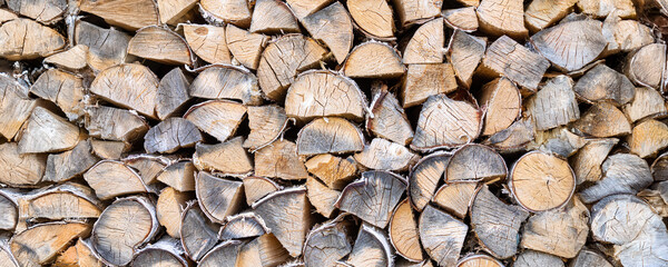 High quality firewood in a woodpile. Banner, background, illustration, postcard for advertising fuel resource for household, timber production, logging,