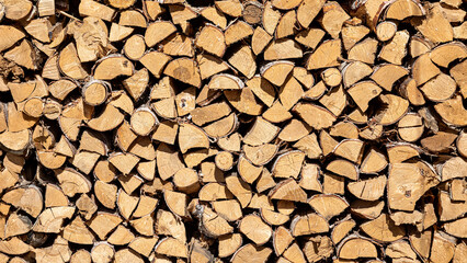 High quality firewood in a woodpile. Banner, background, illustration, postcard for advertising fuel resource for household, timber production, logging,