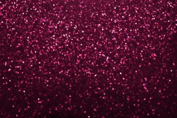 Pink glitter bokeh background with defocused sparkling lights, abstract shiny texture. Holiday lights.