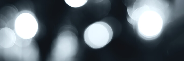 Blurred lights, gray, deep blue background, banner texture. Abstract bokeh with soft light header. Wide screen wallpaper. Panoramic web banner with copy space for design