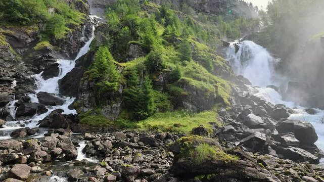 Latefossen Waterfall Cascade in Granvin, Odda, Norway, Scandinavia - Pedestal Down. Big Waterfall in Norway in SloW Motion 4K.