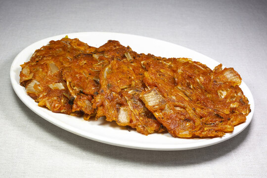 Close-up of Korean Food Mug-eunji Jeon(Ripened Kimchi Pancake) on white round plate, South Korea