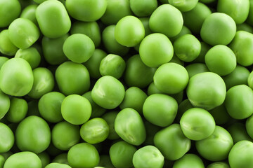 Fresh green peas as background, top view