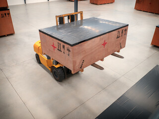 Project cargo in big wooden boxes stored in the warehouse. The cargo in wooden boxes handling by forklift.