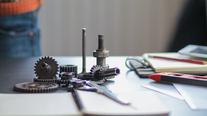 The gear set is placed on the workbench of a team of factory mechanical engineers to study and design the working system of the mechanical gearbox in the factory to complete the production.