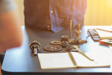 The gear set is placed on the workbench of a team of factory mechanical engineers to study and design the working system of the mechanical gearbox in the factory to complete the production.