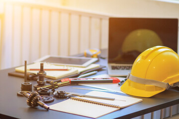 The engineering team's equipment and documents on the desks in the office, as well as the yellow...