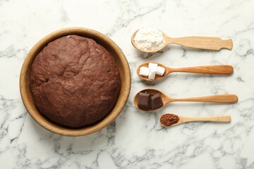 Chocolate dough and ingredients in spoons on white marble table, flat lay