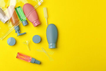 Travel Size Bottles And Containers in a bag On A Yellow Background