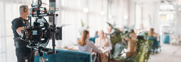 Professional film and video camera on the set. Shooting shift, equipment and group.