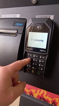 A hand using a Payway payment point.