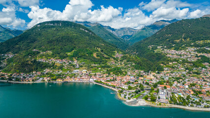 An aerial view of Domaso, a beautiful village nestled on the shores of Lake Como, Italy, captured by a drone. This charming destination is known for its picturesque lakeside scenery, quaint streets