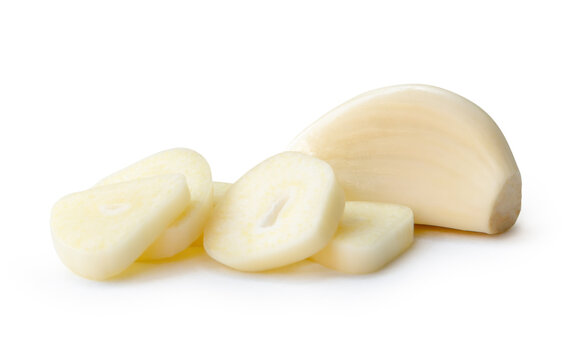 Fresh peeled garlic clove with slices or pieces in stack isolated on white background with clipping path