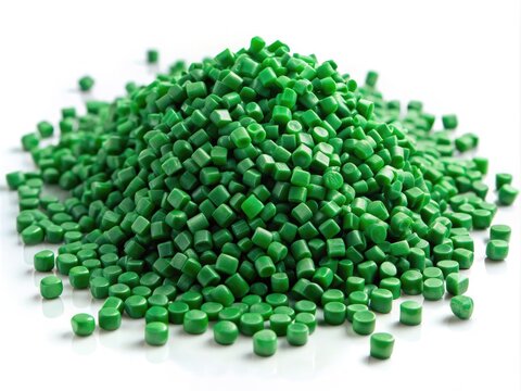 Vibrant clear green masterbatch granules, uniformly sized and shaped, scattered on a pure white background, showcasing color pigment carrier polymer for plastics manufacturing applications.