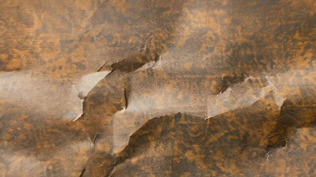 a textured surface resembling aged or decorative paper or fabric, featuring intricate patterns. Visible creases and folds indicate signs of wear and use, hinting at its history.