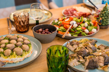 Cose-up of a festive Christmas dinner spread on a wooden table. Homemade dishes
