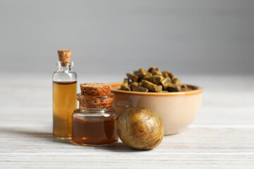 Natural honey tincture and propolis granules on white wooden table