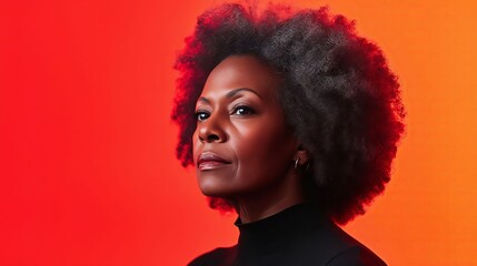 A woman with an afro standing in front of a red and orange background