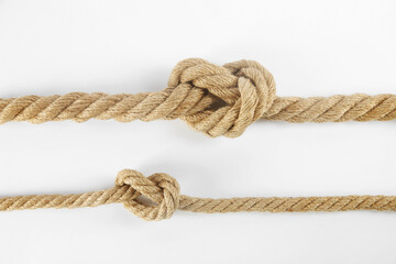Hemp ropes with knots isolated on white, top view