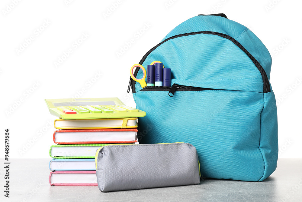 Sticker Backpack with different school stationery on light grey table against white background