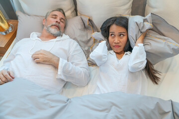 The husband snores loudly, the wife has insomnia, and when they sleep together, it annoys her and...