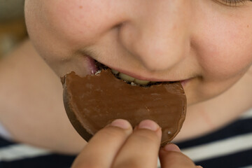 Kid eats food. Focus on the food and face on background