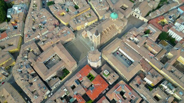An aerial view of Parma, Italy, showcasing the iconic Cattedrale di Parma and the Battistero di Parma, captured by a drone.  This historic city is known for its rich cultural heritage