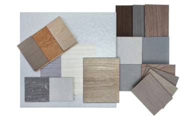 top view of interior material samples board contains ash vinyl flooring tile, stone ceramic tiles, interior fabric wallpapers, wooden laminated flooring isolated on background with clipping path.