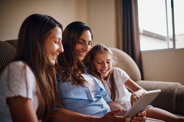 Woman, children and tablet in living room for streaming, e learning and bonding as family. People, happiness and internet tech for education, development and homework as mother and daughter in home