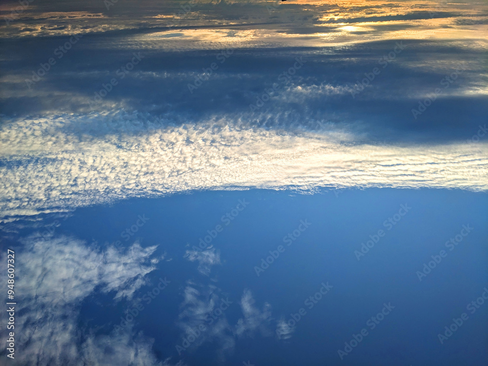 Wall mural dark moody thunder clouds sunset clouds in a blue sky as a skyscape background