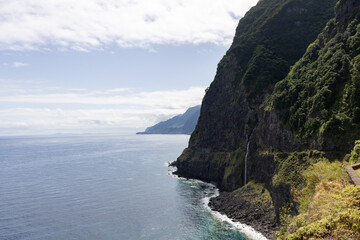 Clifs along Madeira's sea side with a small waterfall