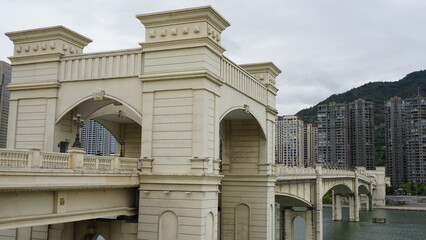 Urban Bridge in the river Ou, Oujiang with Buildings Facade with chinese cityscape and mountains in Qingtian city in china