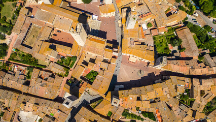 An aerial view of Certaldo, a charming medieval town in Tuscany, Italy, captured by a drone. Certaldo is known for its well-preserved historic center, characterized by ancient brick buildings