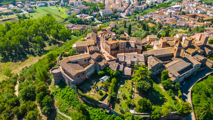 An aerial view of Certaldo, a charming medieval town in Tuscany, Italy, captured by a drone. Certaldo is known for its well-preserved historic center, characterized by ancient brick buildings