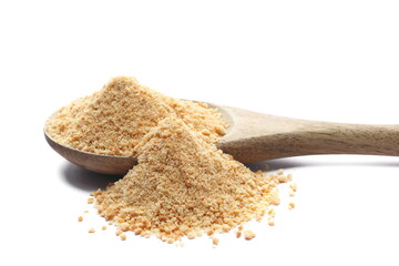 Ground, minced biscuit, pile crumbs in wooden spoon isolated on white, side view