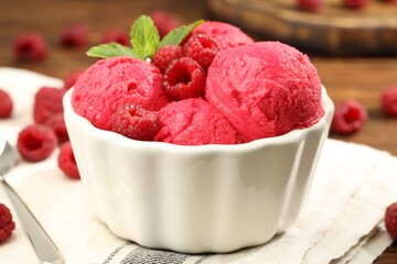 Delicious raspberry sorbet, fresh berries and mint in bowl on table, closeup